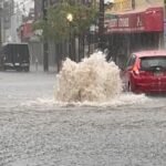 Photo: A car drives in a flooded street after strong downpours in Staten Island, New York
