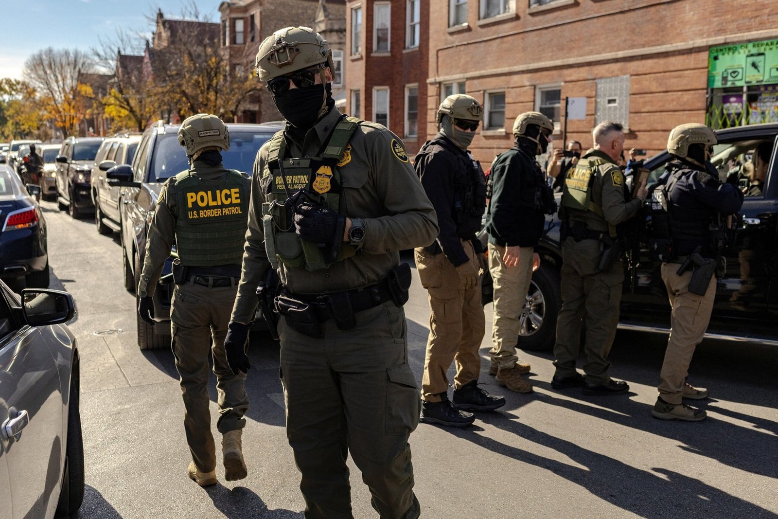 PHOTO: Federal agents confront community members during immigration raids